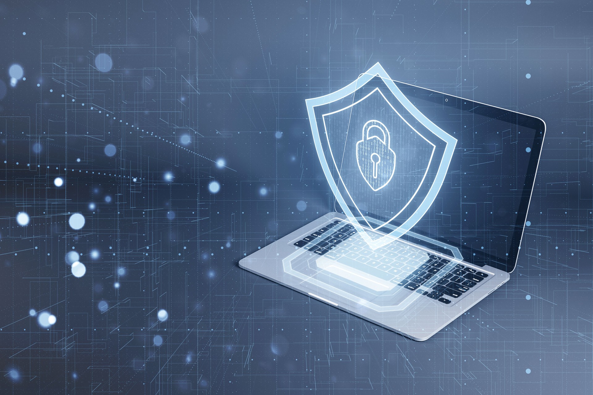 Laptop with a digital shield depicting cybersecurity concept on a blue tech-inspired background Laptop with a digital shield depicting cybersecurity concept on a blue tech-inspired background