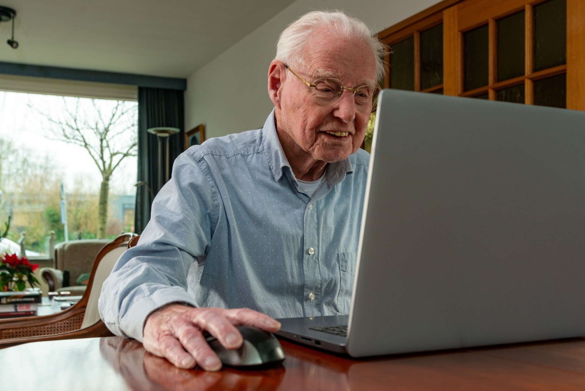 Senior man using laptop at home. Senior man using laptop at home.